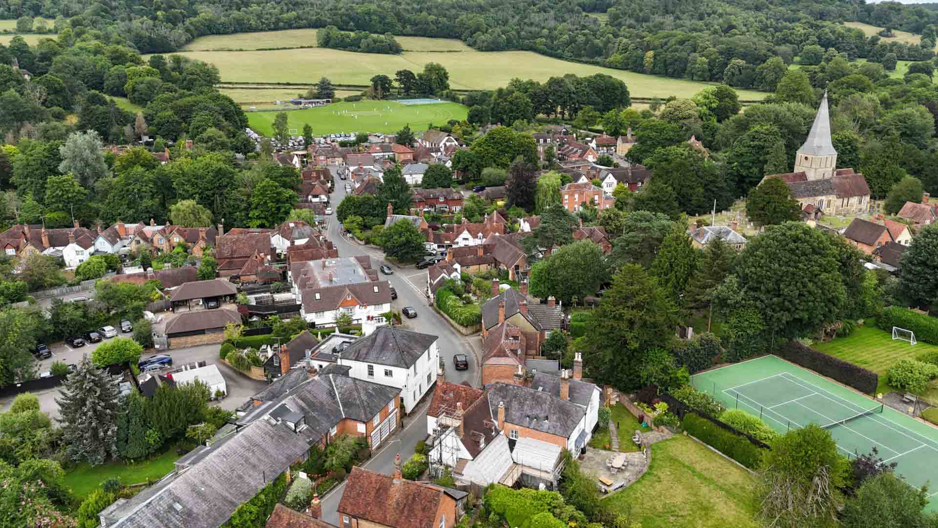 Picturesque view of Shere Village with historic cottages and lush greenery.