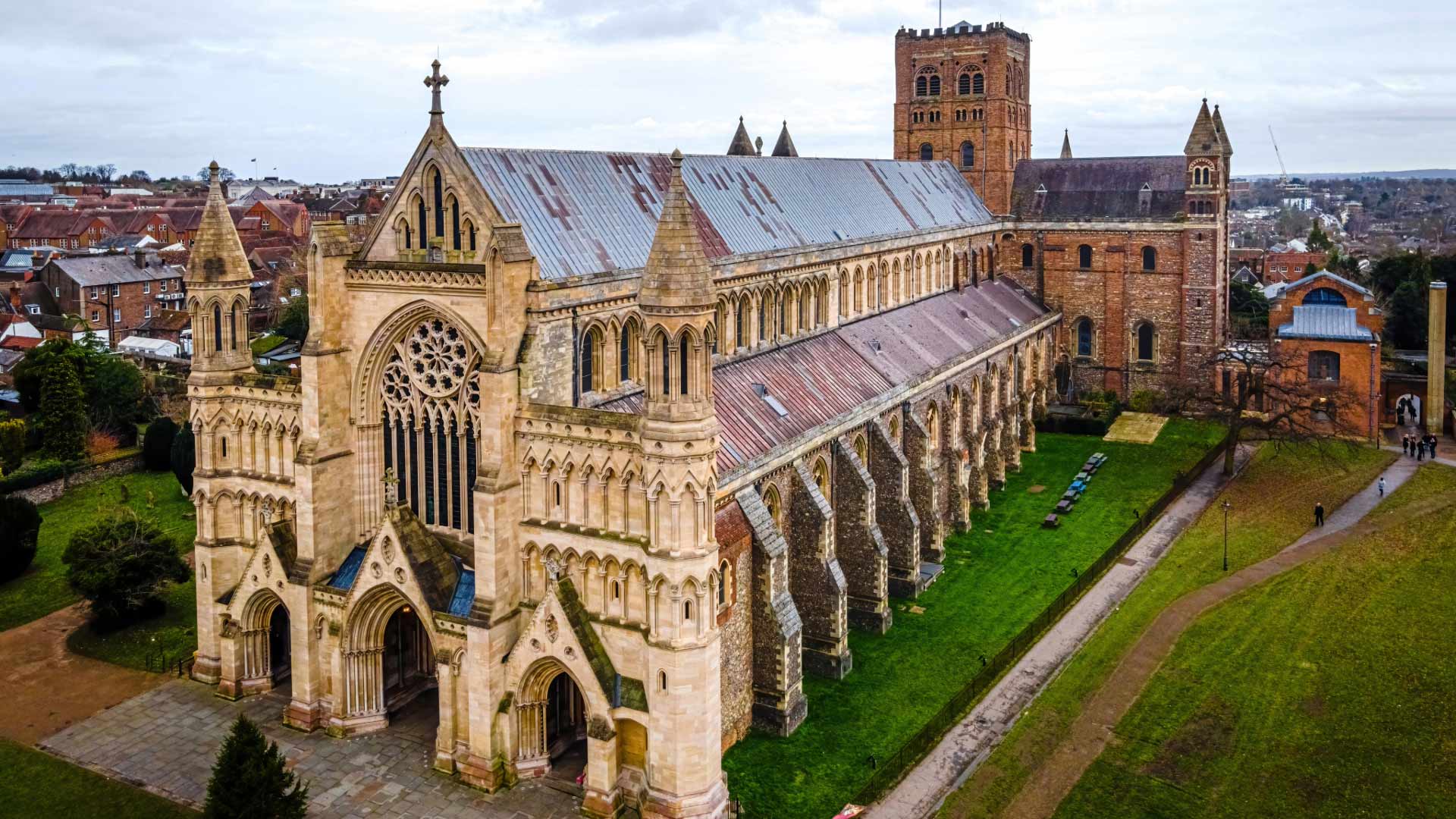 Aerial view of St Albans Abbey in Hertfordshire, UK, showcasing its magnificent medieval architecture and surrounding landscape.